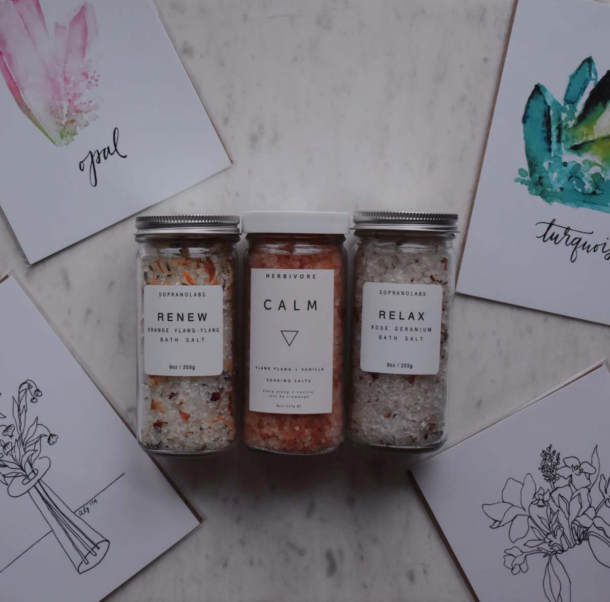 wellness three clear glass jars on white floral table prints